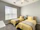 Bedroom with two twin beds, neutral walls, and ceiling fan at 3175 Feltrim Pl # 304, Kissimmee, FL 34747