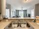 View from the kitchen sink overlooking the living room and balcony beyond at 3175 Feltrim Pl # 304, Kissimmee, FL 34747