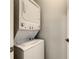 A stacked washer and dryer unit with a white finish is present at 3175 Feltrim Pl # 304, Kissimmee, FL 34747
