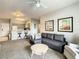 Carpeted living room with ceiling fan, couch and view of kitchen at 3175 Feltrim Pl # 304, Kissimmee, FL 34747