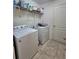 Functional laundry room includes a washer, dryer, and extra storage at 3209 Casa Del Rey Ave, Kissimmee, FL 34746