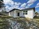 Exterior back of house with covered patio and sliding glass doors at 345 Gardenia Ct, Kissimmee, FL 34759