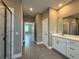 This bathroom features a walk in shower and doorway to a bedroom and vanity at 345 Gardenia Ct, Kissimmee, FL 34759