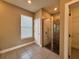 This bathroom features a walk in shower, window, and gray tile flooring at 345 Gardenia Ct, Kissimmee, FL 34759