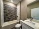 Bathroom featuring modern tiling in the shower/tub area and a sink with white countertops at 345 Gardenia Ct, Kissimmee, FL 34759