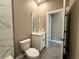 This bathroom features a vanity, toilet, and gray tile flooring at 345 Gardenia Ct, Kissimmee, FL 34759