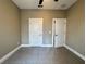 Bedroom with neutral walls, tiled floor, and two doors at 345 Gardenia Ct, Kissimmee, FL 34759