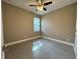 Bedroom with neutral walls, tiled floor, ceiling fan, and a window with blinds at 345 Gardenia Ct, Kissimmee, FL 34759