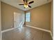 Bedroom with neutral walls, tiled floor, ceiling fan, and a window with blinds at 345 Gardenia Ct, Kissimmee, FL 34759