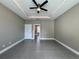 The bedroom features tile floors, and a tray ceiling with lights and fan at 345 Gardenia Ct, Kissimmee, FL 34759