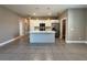 A spacious open kitchen featuring an island, stainless steel appliances, and white cabinets at 345 Gardenia Ct, Kissimmee, FL 34759