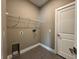 Laundry room with a utility sink and overhead wire shelving at 345 Gardenia Ct, Kissimmee, FL 34759