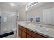 Bright bathroom featuring a double sink vanity and a glass-enclosed shower at 3658 Caruso Pl, Oviedo, FL 32765