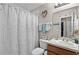 Modest bathroom featuring a single sink vanity and a shower with a white patterned curtain at 3658 Caruso Pl, Oviedo, FL 32765