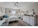 Cozy bedroom with a ceiling fan, window, and a dresser with a decorative mirror at 3658 Caruso Pl, Oviedo, FL 32765