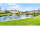 Scenic view of a pond with a fountain in a well-maintained community at 3658 Caruso Pl, Oviedo, FL 32765