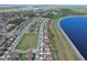 Aerial shot of residential community near lake featuring green spaces and organized street grid at 411 Lazio Cir, Debary, FL 32713