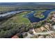 Aerial view of a waterfront property surrounded by dense trees and scenic views at 411 Lazio Cir, Debary, FL 32713