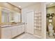 Beautiful bathroom with granite counters, double sinks, large mirror, and stylish decor at 411 Lazio Cir, Debary, FL 32713