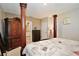 This bedroom features a four-poster bed, an armoire, and an ensuite bathroom at 411 Lazio Cir, Debary, FL 32713