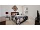 Cozy bedroom with a floral-patterned comforter and a decorative wall art above the headboard at 411 Lazio Cir, Debary, FL 32713