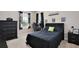 Bedroom designed for a gamer featuring a black furniture set and a gaming-themed wall decor at 411 Lazio Cir, Debary, FL 32713