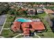 Aerial view of a large community pool area surrounded by tropical landscaping at 411 Lazio Cir, Debary, FL 32713