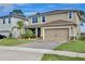 Attractive two-story home features well-maintained lawn and convenient two-car garage at 411 Lazio Cir, Debary, FL 32713