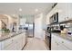 Stylish kitchen featuring stainless steel appliances, granite countertops, and a convenient pantry at 411 Lazio Cir, Debary, FL 32713