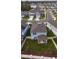 Aerial view showcases the backyard with a covered patio and well-maintained lawn at 5017 Blue Hammock Ct, Kissimmee, FL 34746