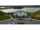 A beautiful aerial view showcases the community pool and splash pad, and lake at 5017 Blue Hammock Ct, Kissimmee, FL 34746