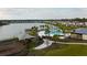 A beautiful aerial view of the community pool, splash pad, playground, and lake at 5017 Blue Hammock Ct, Kissimmee, FL 34746