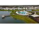 Aerial view featuring a community pool, playground, lake, and dock at 5017 Blue Hammock Ct, Kissimmee, FL 34746