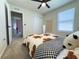 Bedroom with a light-filled window, ceiling fan, closet and neutral carpet and color scheme at 5017 Blue Hammock Ct, Kissimmee, FL 34746