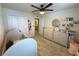 Bedroom featuring neutral tones, plush carpet, and a delightful decorative mobile above the baby's crib at 5017 Blue Hammock Ct, Kissimmee, FL 34746