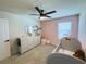 Bright Bedroom featuring a grey crib, changing table, and pink accents creating a serene and stylish space at 5017 Blue Hammock Ct, Kissimmee, FL 34746