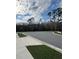 Empty cul-de-sac surrounded by sidewalks and green grass on a sunny day at 5017 Blue Hammock Ct, Kissimmee, FL 34746