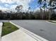 Empty cul-de-sac surrounded by trees and green grass at 5017 Blue Hammock Ct, Kissimmee, FL 34746