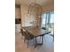 Dining area featuring table with unique light fixture and sliding glass door to the exterior at 5017 Blue Hammock Ct, Kissimmee, FL 34746