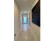 Bright hallway with tiled floor and accent art, showcasing entry access at 5017 Blue Hammock Ct, Kissimmee, FL 34746