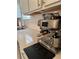 Close up of the stainless Breville espresso machine with a white countertop and backsplash at 5017 Blue Hammock Ct, Kissimmee, FL 34746