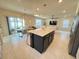 Open floor plan featuring kitchen island, dining area and living room at 5017 Blue Hammock Ct, Kissimmee, FL 34746