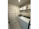 Efficient laundry room featuring a washer, dryer, drying rack, and shelving for organized convenience at 5017 Blue Hammock Ct, Kissimmee, FL 34746