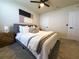 Well-lit bedroom featuring a ceiling fan, bedside table, and an upholstered bed frame at 5017 Blue Hammock Ct, Kissimmee, FL 34746