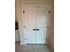 White double doors leading to a pantry with black hardware at 5017 Blue Hammock Ct, Kissimmee, FL 34746