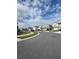 Picturesque street view shows the neighborhood with beautiful homes, well-kept lawns, and streetscaping at 5017 Blue Hammock Ct, Kissimmee, FL 34746