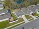 Aerial view of a home with a backyard and landscaped lawn in a quiet neighborhood near a pond at 5315 Meadow Song Dr, Okahumpka, FL 34762