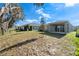 View of the backyard, featuring a grassy area, and access to the covered patio at 5315 Meadow Song Dr, Okahumpka, FL 34762