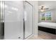 Modern bathroom features a glass enclosed shower and natural light at 5315 Meadow Song Dr, Okahumpka, FL 34762