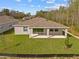 Spacious backyard with covered patio, perfect for outdoor entertaining and relaxation at 5376 Dagenham Dr, Davenport, FL 33837